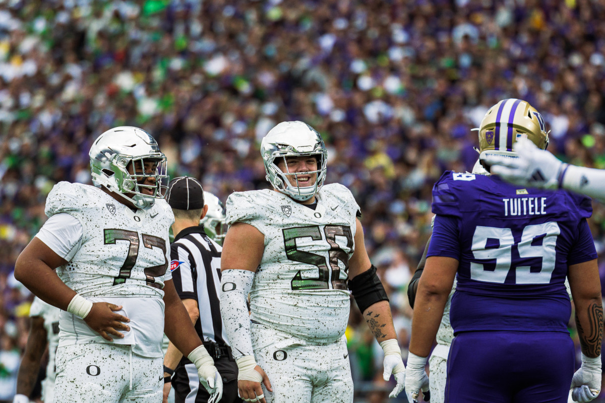 Oregon Ducks offensive lineman Iapani Laloulu (72) with center Jackson Powers-Johnson (58) during a game against the Washington Huskies.